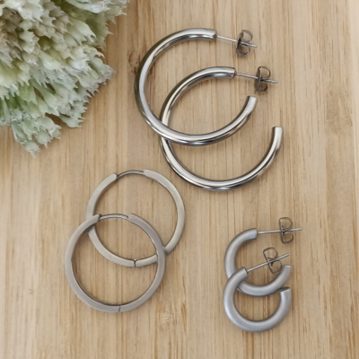 Three pairs of titanium hoop earrings.